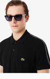 Polo Lacoste nera con banda logata
